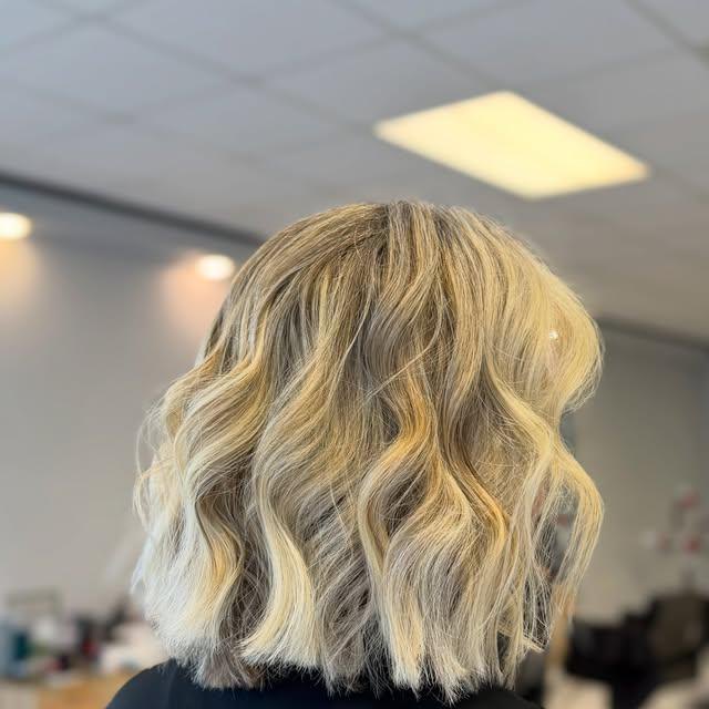 Blonde textured lob, cut to the jaw and finished in a beachy wave.